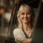 Sarah Williams in her taxi looking into the camera